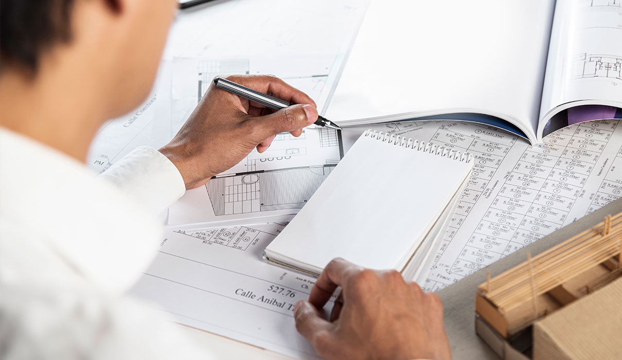 Engineer reviewing commercial sign permit drawings in Florida